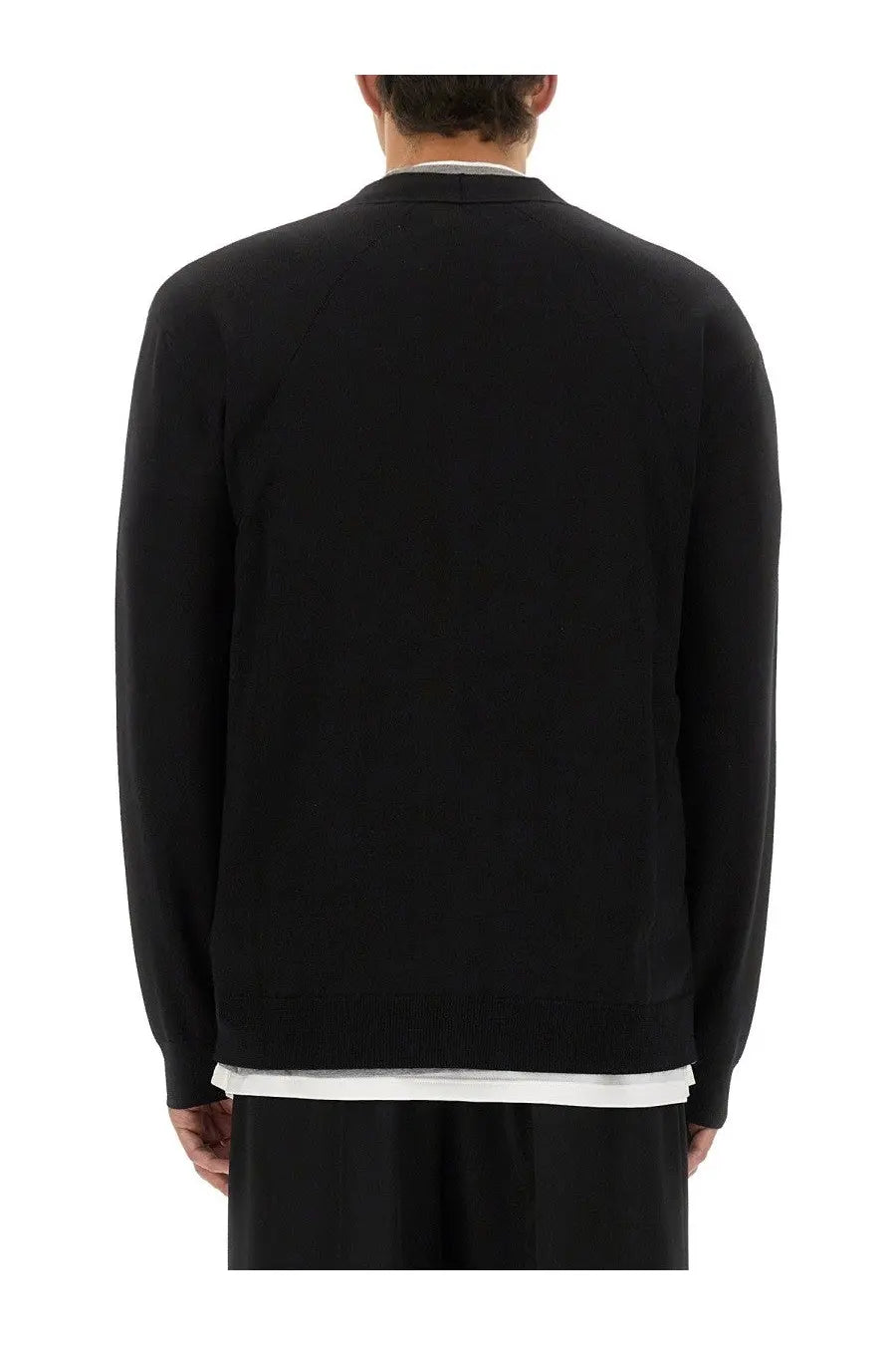 Black jil sander men’s merino wool cardigan with ribbed crew neckline and cuffs worn over white collared shirt
