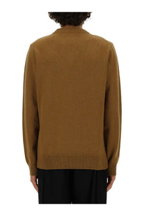 A warm camel-colored long-sleeved knit sweater with ribbed crew neckline and cuffs from Jil Sander mens neck sweater beige