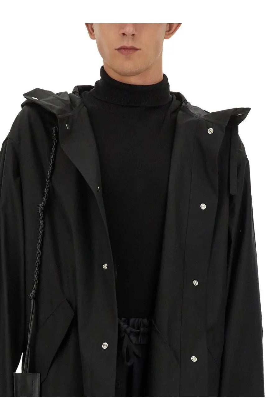 Black hooded trench coat with silver buttons and braided drawstring detail from jil sander men’s parka collection