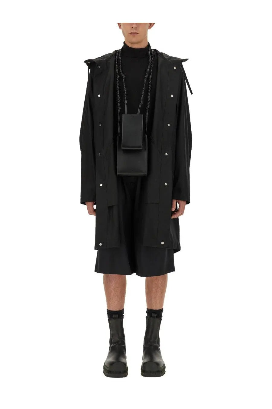 Black rectangular crossbody bag with chain strap and minimalist design paired with jil sander mens parka black