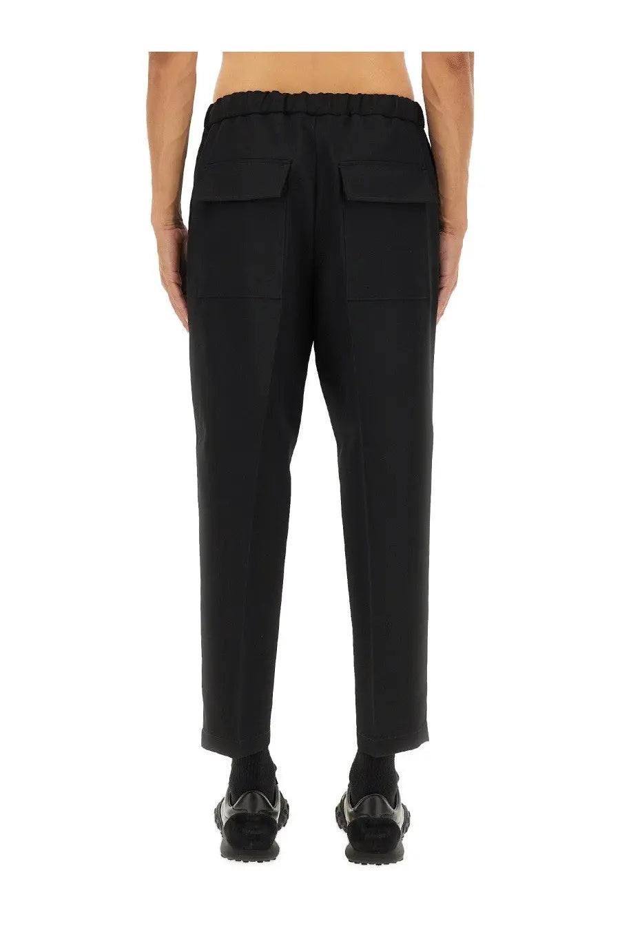 Jil Sander men’s tapered pants in black with elastic waistband and two large patch pockets in cotton blend fabric