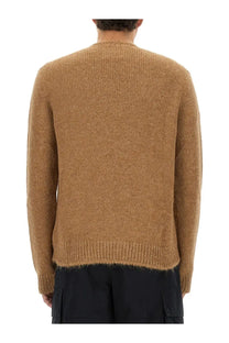 A textured camel-colored knit wool blend sweater with ribbed hem and cuffs from Jil Sander men’s collection