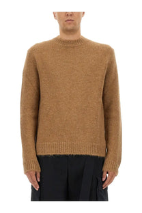 A warm camel-colored ribbed-knit wool blend sweater with a classic crew neck and long sleeves by Jil Sander men