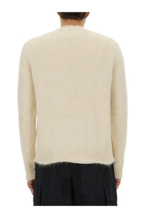 Cream-colored jil sander men’s wool blend sweater with textured knit and ribbed hem and cuffs in white