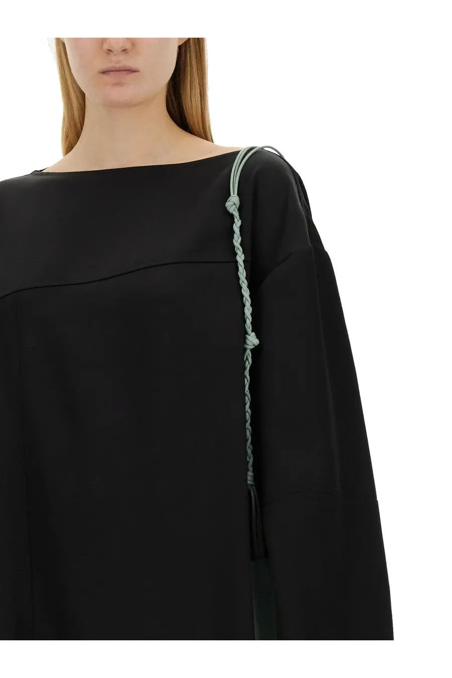 Jil sander women’s asymmetrical black top with a delicate light green braided strap and tassel on the shoulder