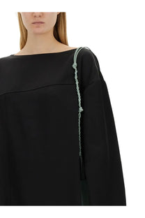 Jil sander women’s asymmetrical black top with a delicate light green braided strap and tassel on the shoulder