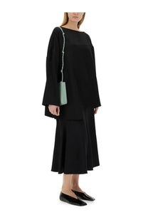 Jil sander women’s asymmetrical top in black long-sleeved knit with boat neckline for elegant wear
