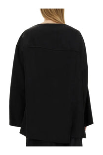 Jil Sander women’s black oversized blouse with relaxed fit and bell sleeves in soft fabric for casual wear
