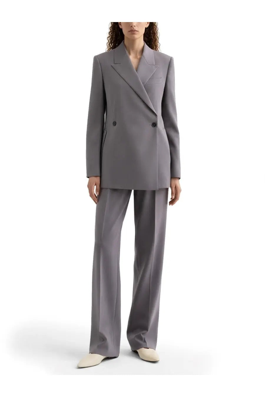 A sleek tailored gray double breasted wool blazer with structured silhouette and subtle lapel details by Jil Sander