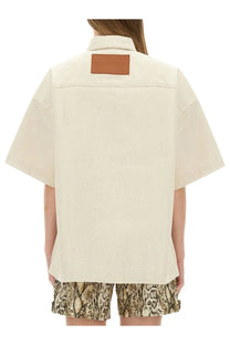 Cream-colored jil sander women’s heavy cotton shirt with brown leather patch at the collar
