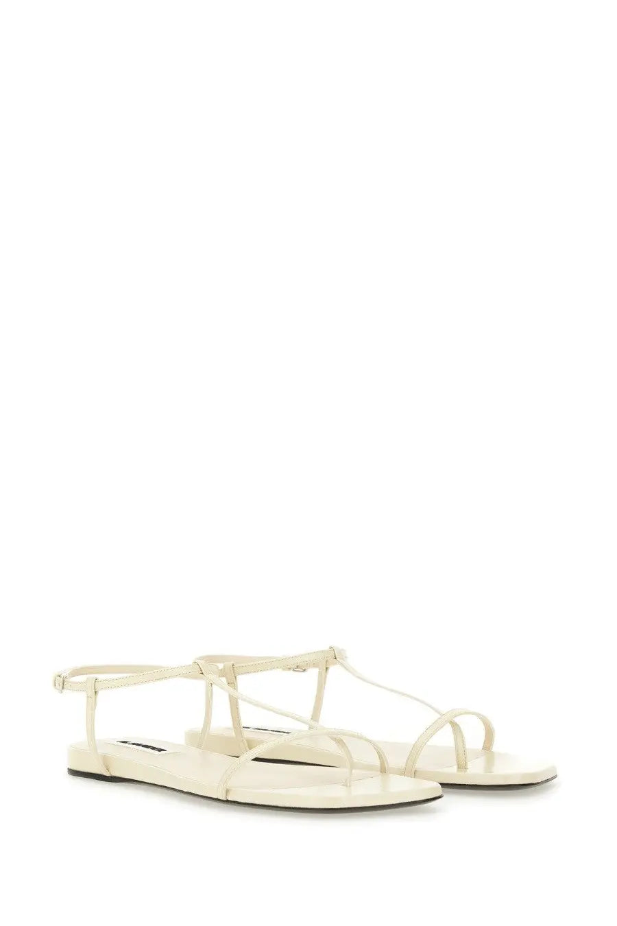 Jil Sander women’s cream leather minimalist sandals with thin straps and a flat sole