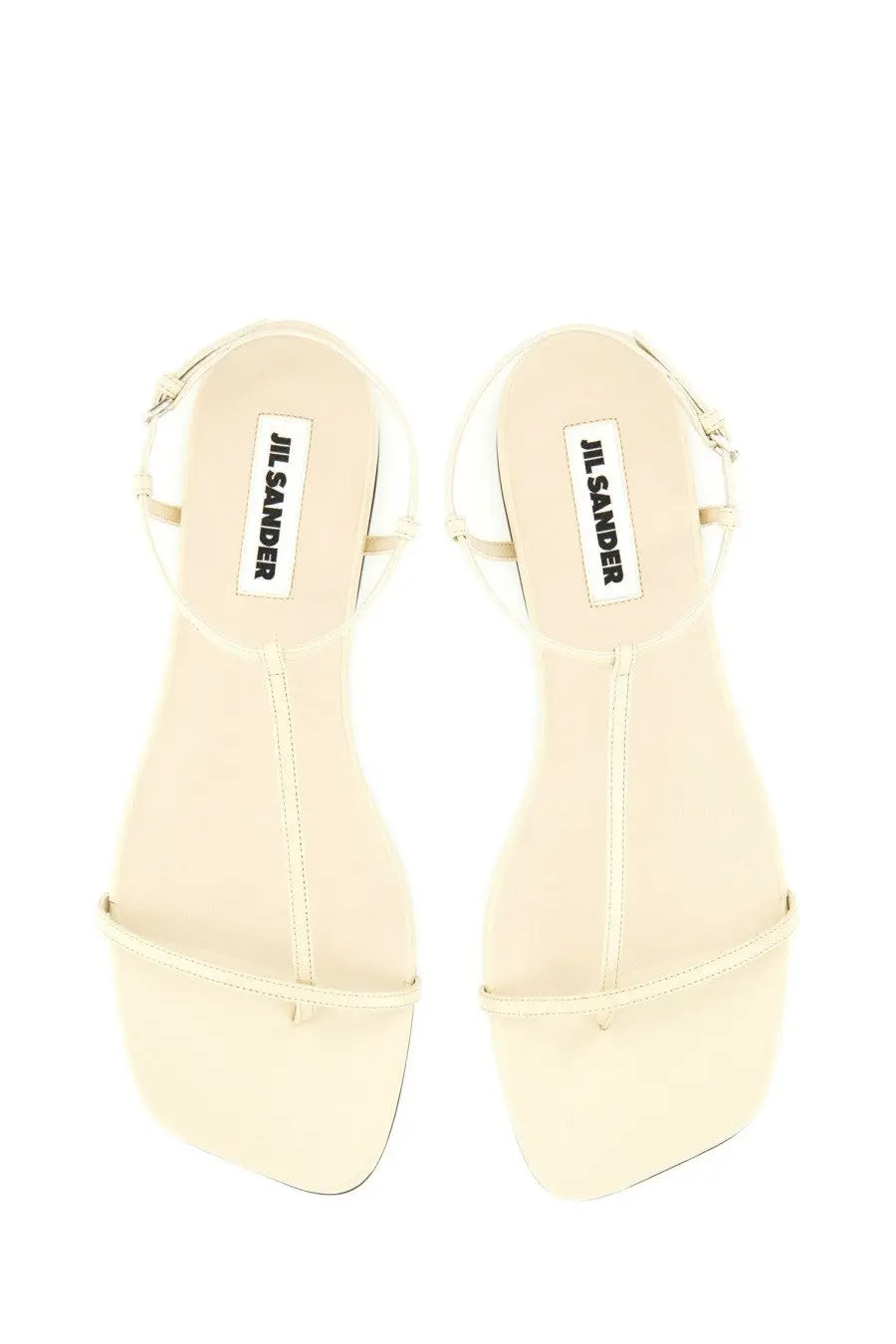 Cream-colored jil sander women’s leather sandal with minimalist design and thin straps in white color