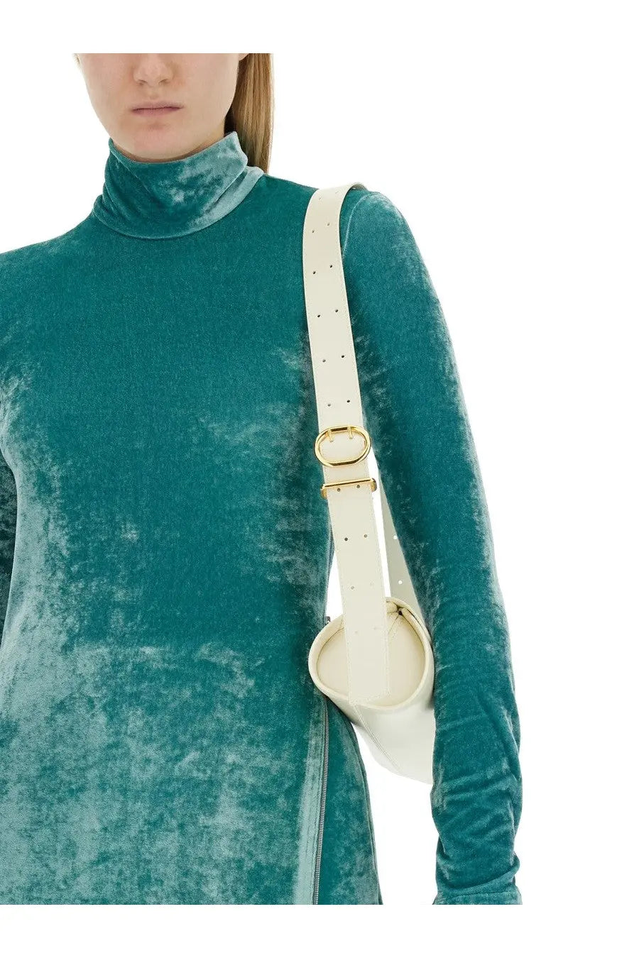 A cream-colored leather shoulder bag with gold-tone buckle and adjustable strap paired with jil sander blue top