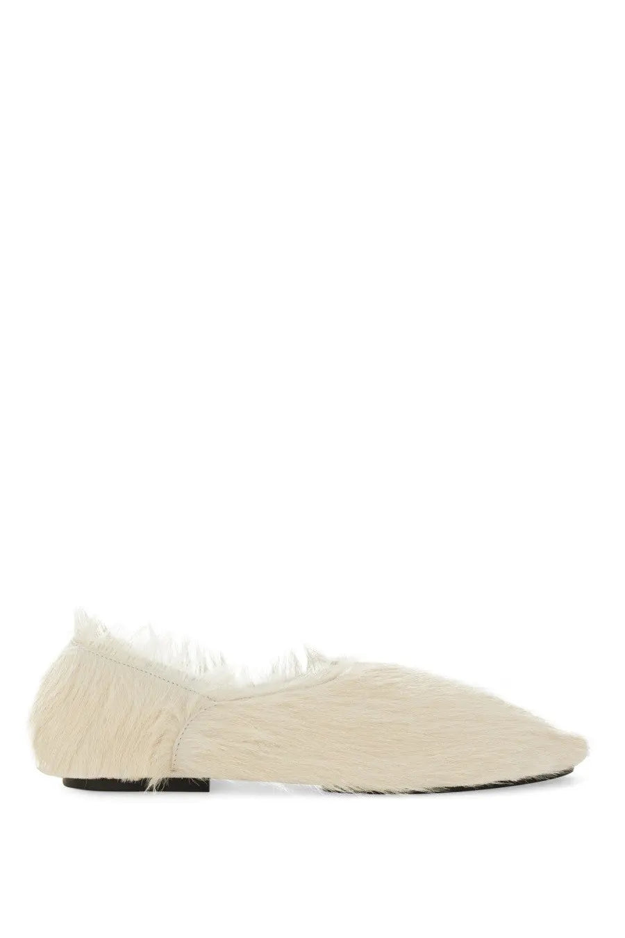 Cream-colored jil sander women’s low leather slipper with soft textured fur-like upper and black sole front view