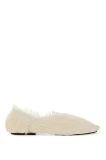 Cream-colored jil sander women’s low leather slipper with soft textured fur-like upper and black sole front view