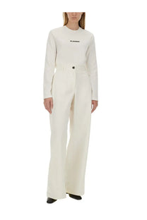 Jil Sander women’s cream-colored long-sleeved jumpsuit with high neckline and front button closure