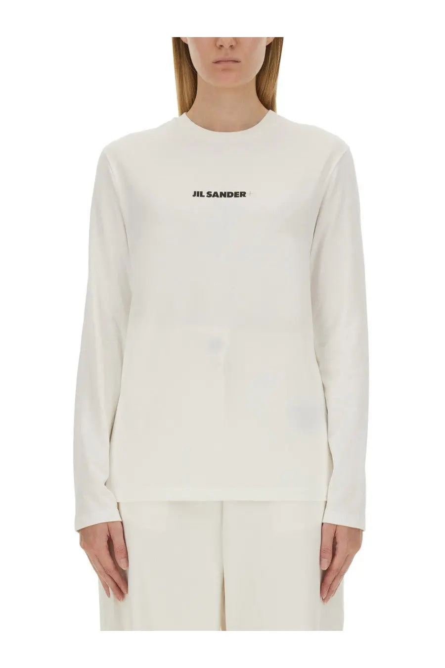 Cream-colored long-sleeved cotton top with black jil sander logo printed across the chest for women
