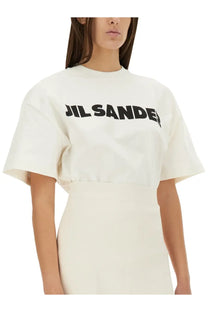 Cream-colored Jil Sander women’s cropped t-shirt with bold black lettering across the chest in soft fabric