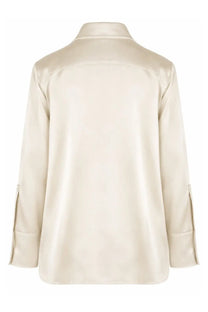 Cream-colored satin blouse by Jil Sander with classic collar and rolled cuffs for women’s elegant shirt style
