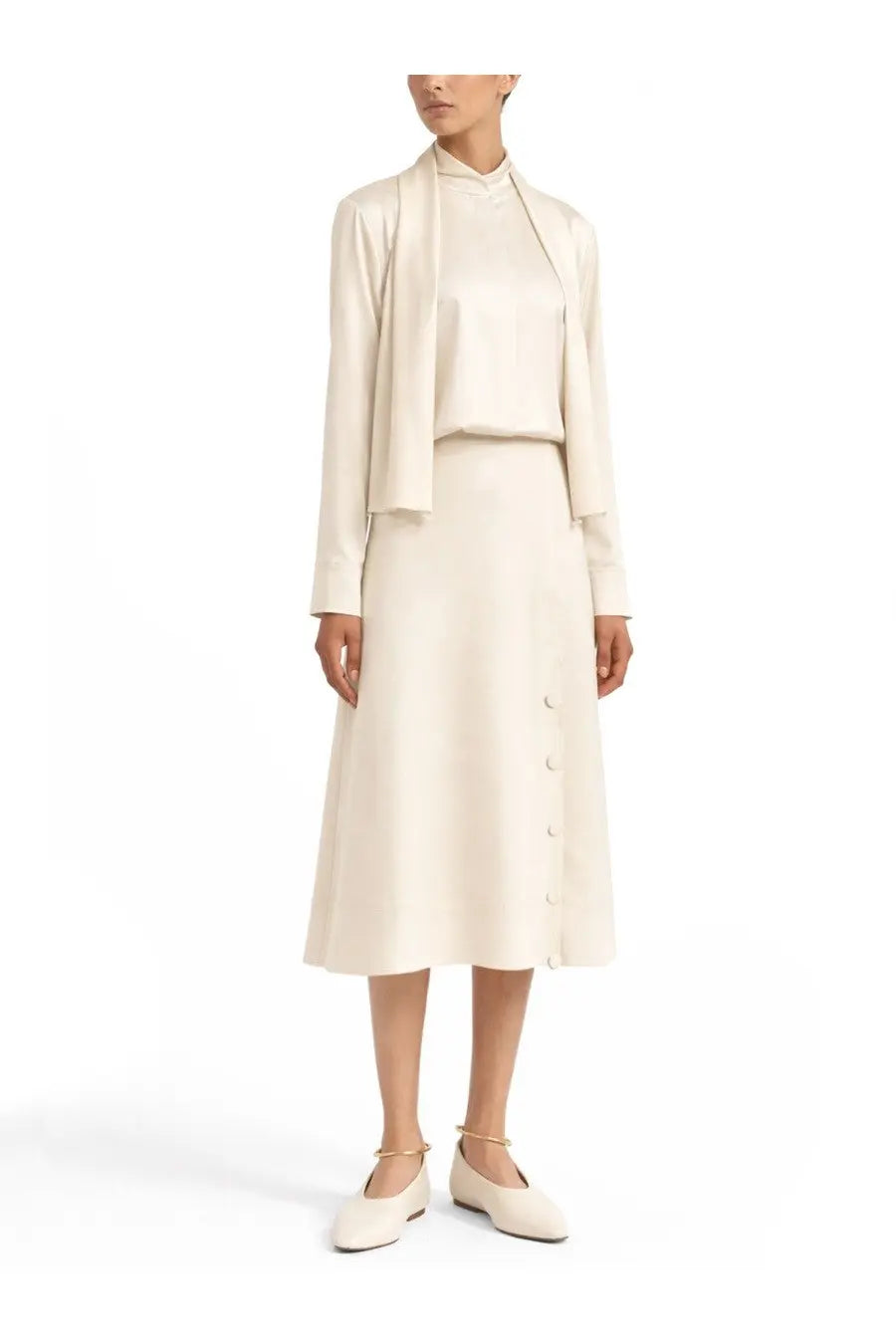 Cream-colored silk midi skirt with button-front detail and soft flowing silhouette paired with jil sander white shirt
