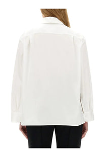 A crisp white jil sander women’s shirt with long sleeves, button-down front, classic collar, and subtle shoulder pleats