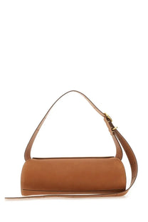 Jil Sander women’s small cannoli bag in tan leather with a cylindrical shape, slender adjustable strap, and gold-tone hardware