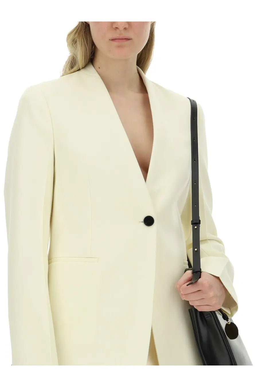 Cream-colored jil sander women’s tailored blazer with single black button and structured shoulders for formal wear