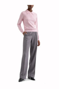A soft pink long-sleeved knit polo shirt with classic collar and ribbed cuffs paired with jil sander grey wool gabardine pants