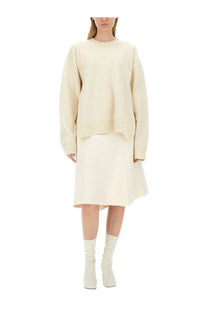 Cream-colored oversized wool sweater with ribbed cuffs and hem by jil sander for women in white