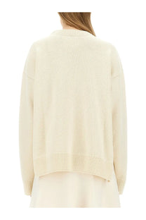Cream-colored jil sander women’s wool sweater with ribbed knit, relaxed fit, and crew neckline in white