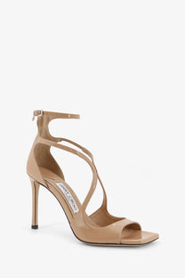Beige patent leather jimmy choo high-heeled sandal with crisscross straps and slender stiletto heel for women