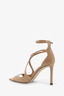 Jimmy Choo women’s Azia beige patent leather strappy high heel sandal with sleek minimalist design and ankle strap