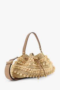Beige woven jimmy choo women’s bon bon rafia bag with pom-pom embellishments and tan leather straps