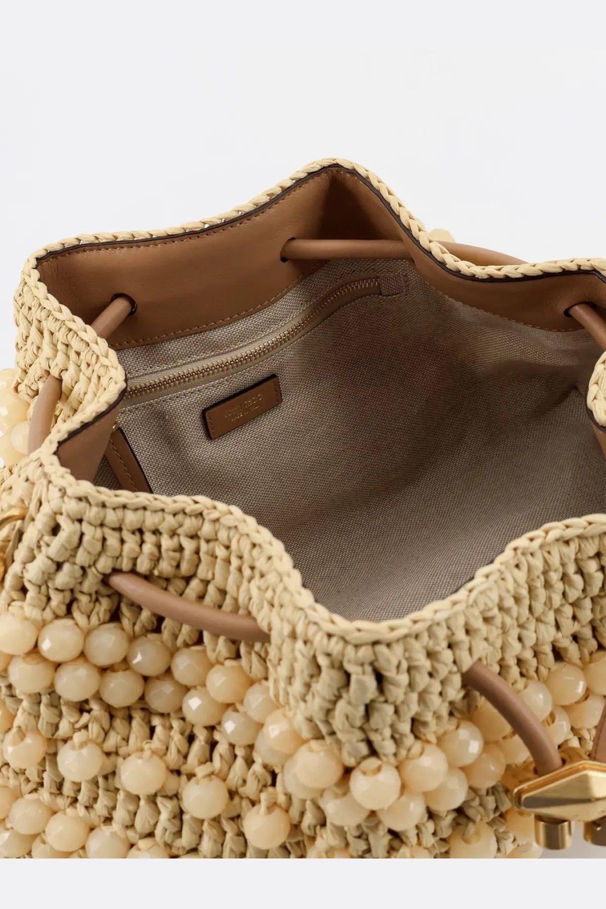 Beige woven straw bucket bag with cream beads and tan leather drawstrings from Jimmy Choo bon bon rafia collection white