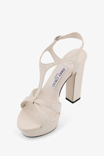 Cream-colored jimmy choo womens kesia leather platform sandal with block heel and crisscross strap design
