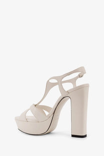 Cream-colored Jimmy Choo women’s Kesia leather platform sandals with thick block heel and crisscross ankle straps
