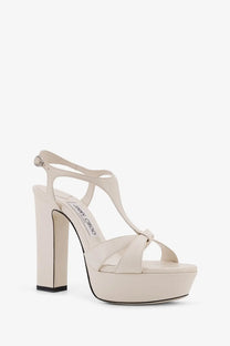 Cream-colored Jimmy Choo women’s Kesia platform sandal with glossy leather and elegant t-strap design