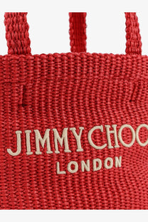 A vibrant red woven raffia crossbody tote bag featuring the jimmy choo london logo in cream embroidery