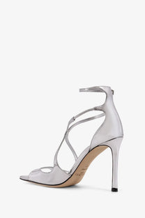 Jimmy Choo women’s silver patent leather strappy high heel sandal with sleek minimalist design and ankle strap