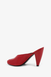 Red patent leather jude women’s paw mule sandal with sleek tapered heel and open back shown from back side