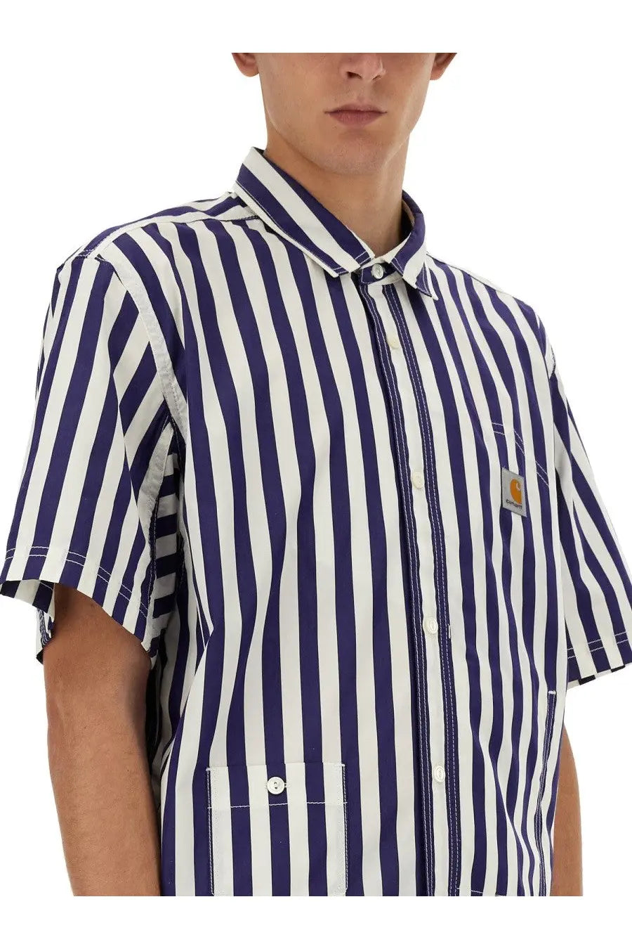 Navy and white vertically striped short-sleeved button-up shirt with carhartt patch from junya watanabe man