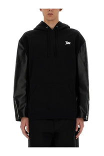 Black hoodie with faux leather sleeves and white patta logo on chest from junya watanabe man flap sweatshirt black