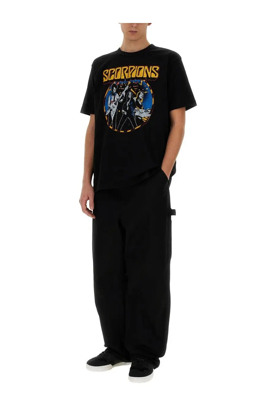 Black short-sleeved junya watanabe man t-shirt featuring vibrant scorpions graphic in blue white and gold with yellow lettering