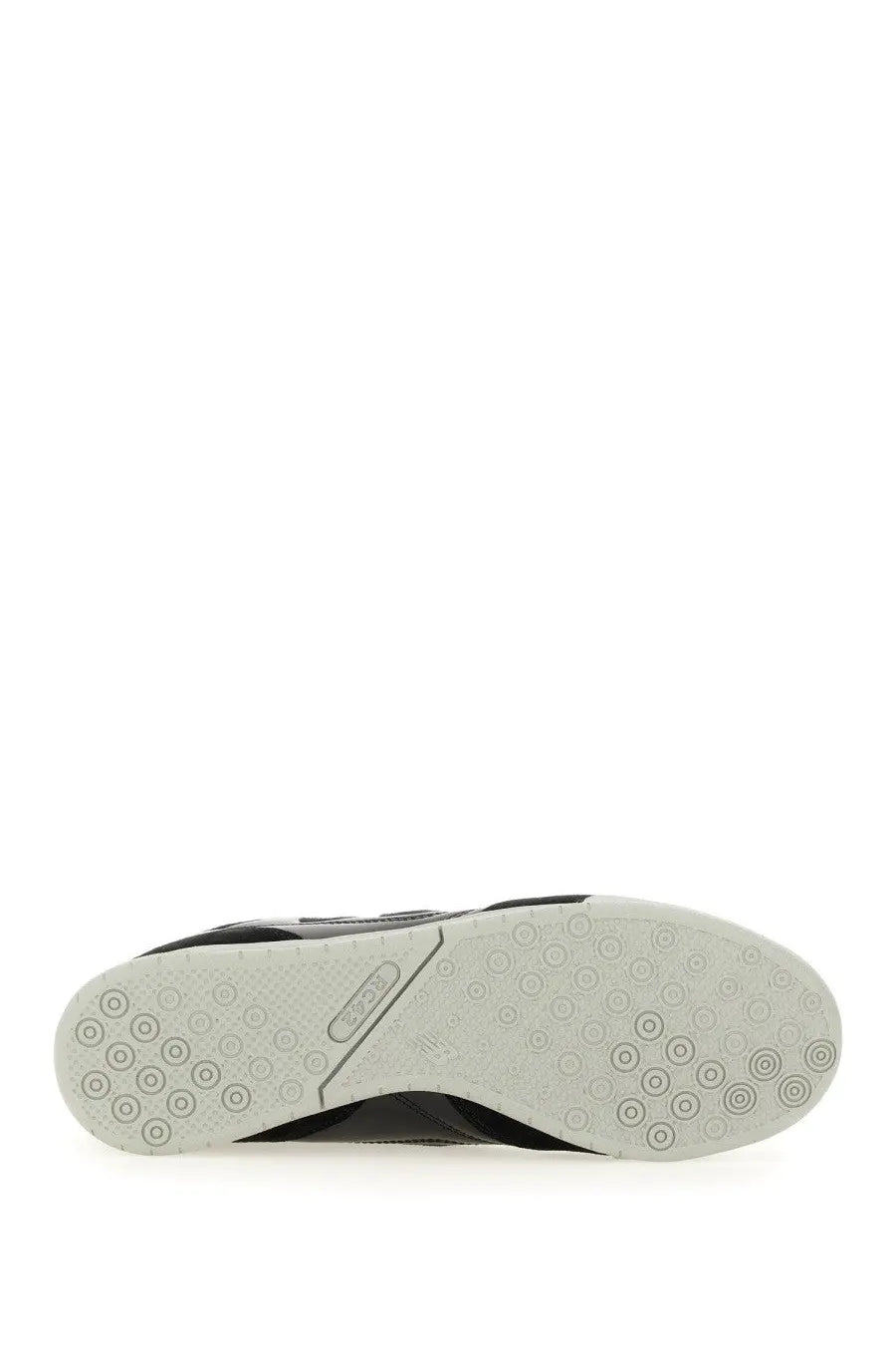 Back view of Junya Watanabe Man men’s black athletic sneaker with white rubber sole and reebok logo on heel
