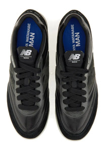 Junya Watanabe Man New Balance black men’s sneaker RC42 with sleek glossy finish and blue insoles branding