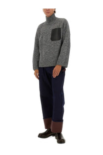JW Anderson men’s grey turtleneck shirt with a gray textured knit and black leather chest patch