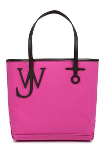 Bright pink canvas tote bag with black leather handles and bold jw monogram logo by JW Anderson unisex borsa tote