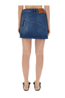 Jw anderson women’s blue denim miniskirt with diagonal seam and brown leather patch at the waistband