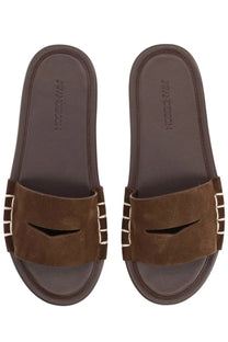 Jw anderson women’s brown leather slide sandals with a stitched strap and white vertical stripes on the sides