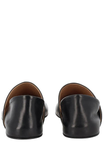 JW Anderson women’s black leather loafers with smooth glossy finish and tan lining for stylish everyday wear